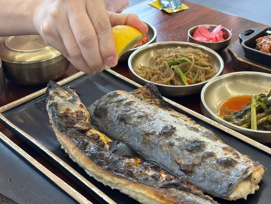 A full spread of grilled fish shared among a group
