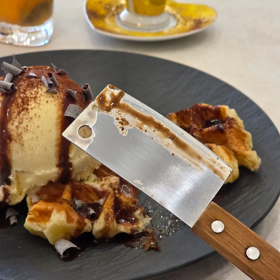 Croffle topped with chocolate syrup and ice cream
