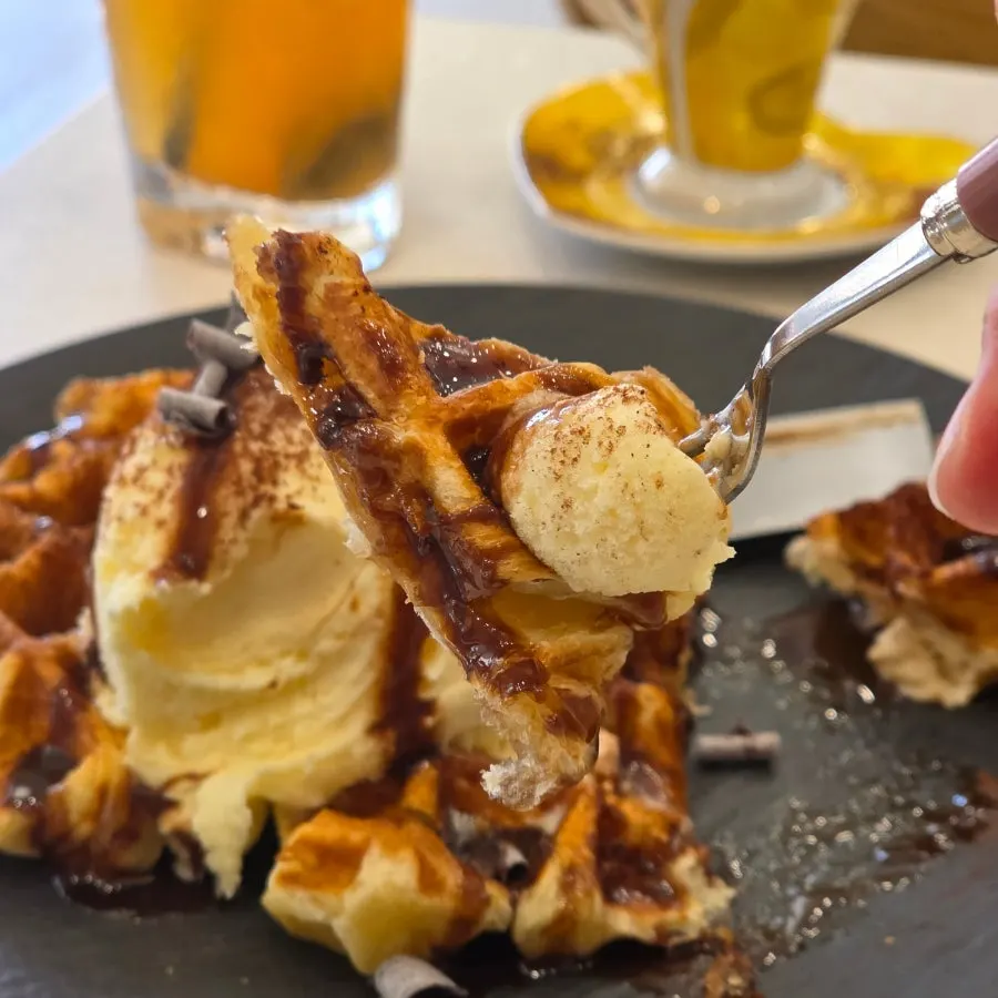 A cut piece of croffle topped with ice cream
