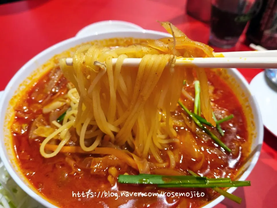 Jjamppong noodles lifted with chopsticks