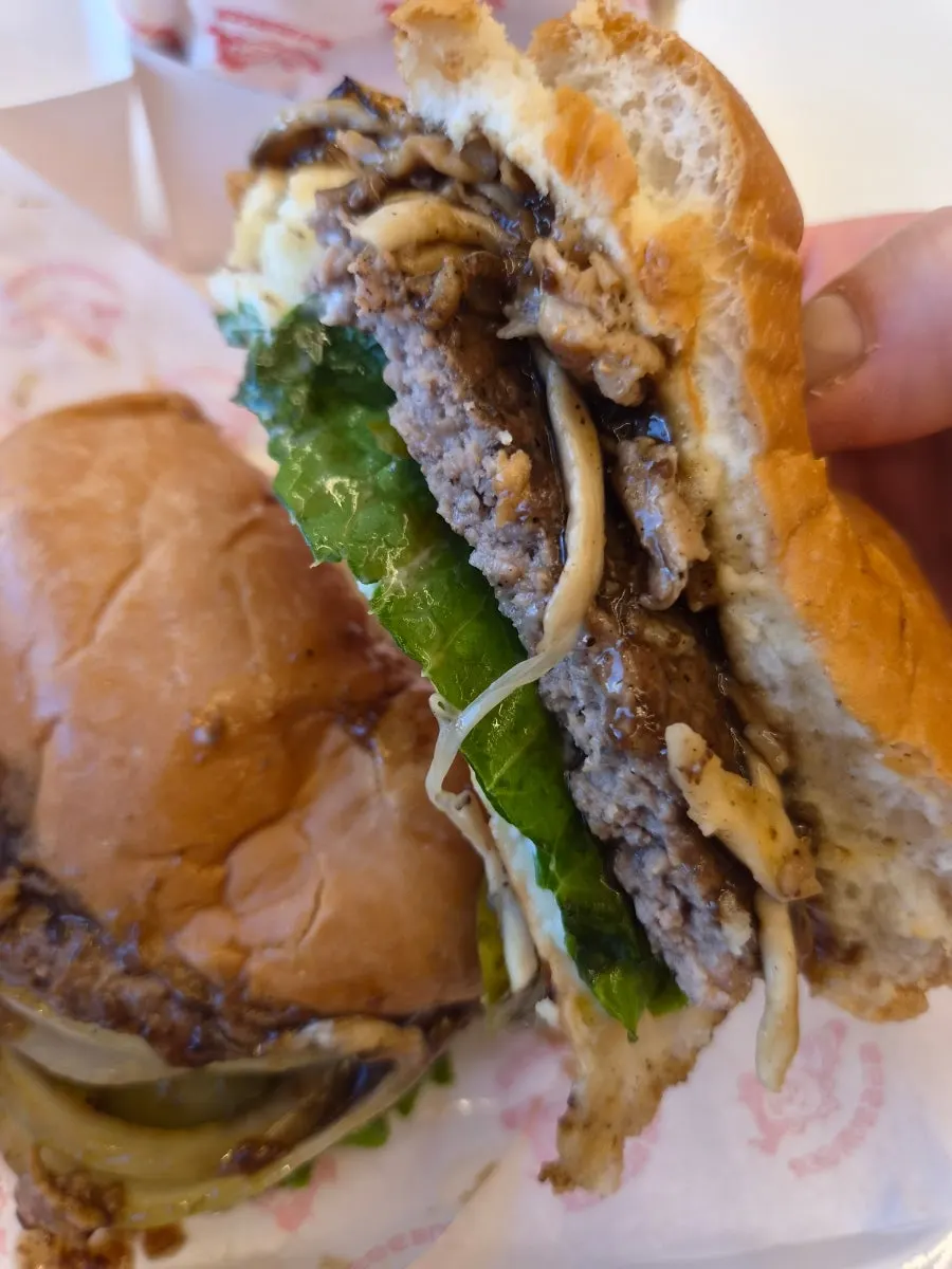 Cross-section of a handmade burger with a bite taken out