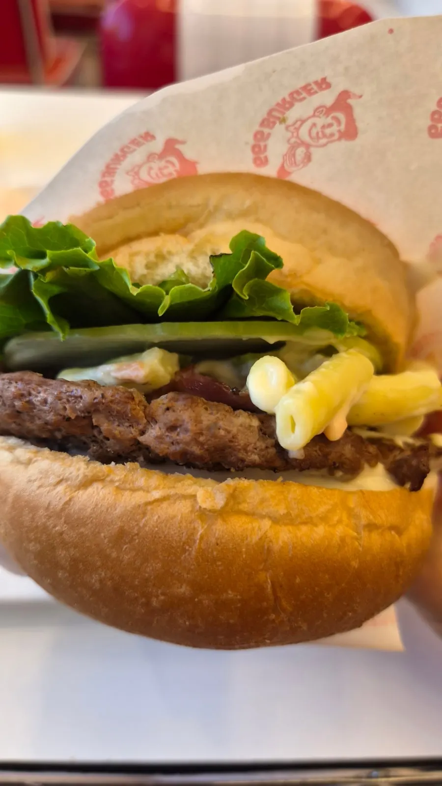 Handmade burger from 666 Burger Main Branch held in hand
