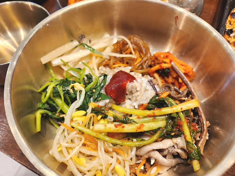 Barley rice and namul served in a brass bowl