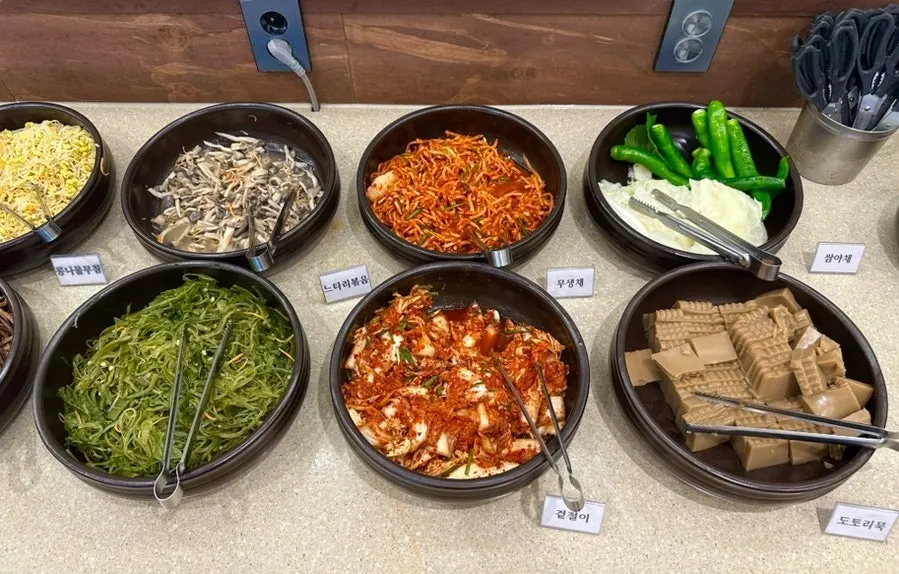 Side dishes and wrap greens laid out on the self-serve bar