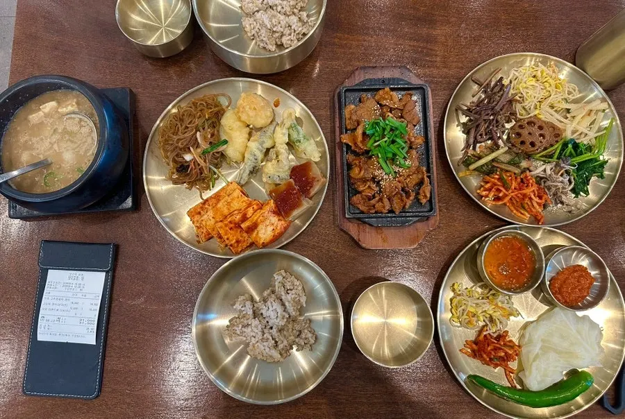 A full spread of barley rice topped with namul