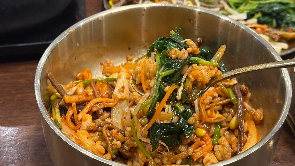 Barley bibimbap mixed with all the gathered ingredients