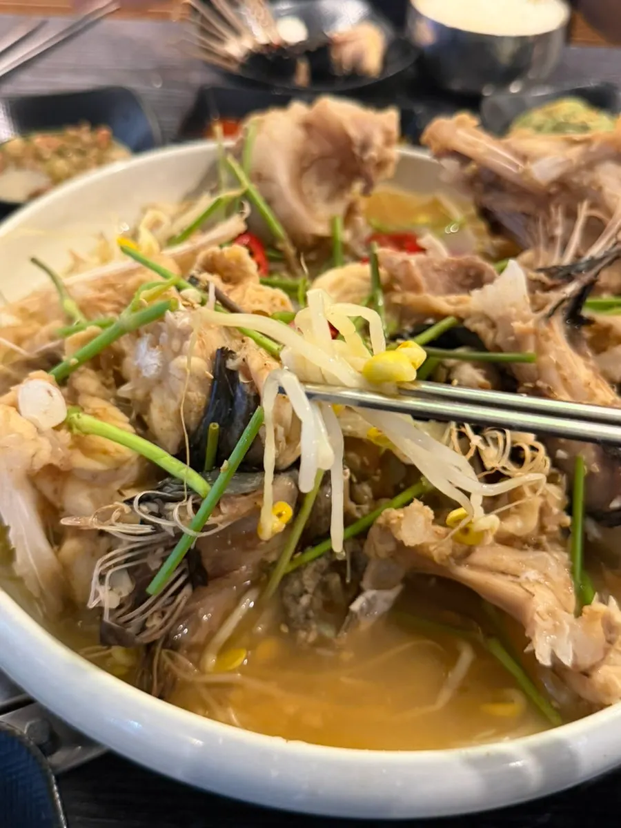 Agu suyuk served over bean sprouts and minari