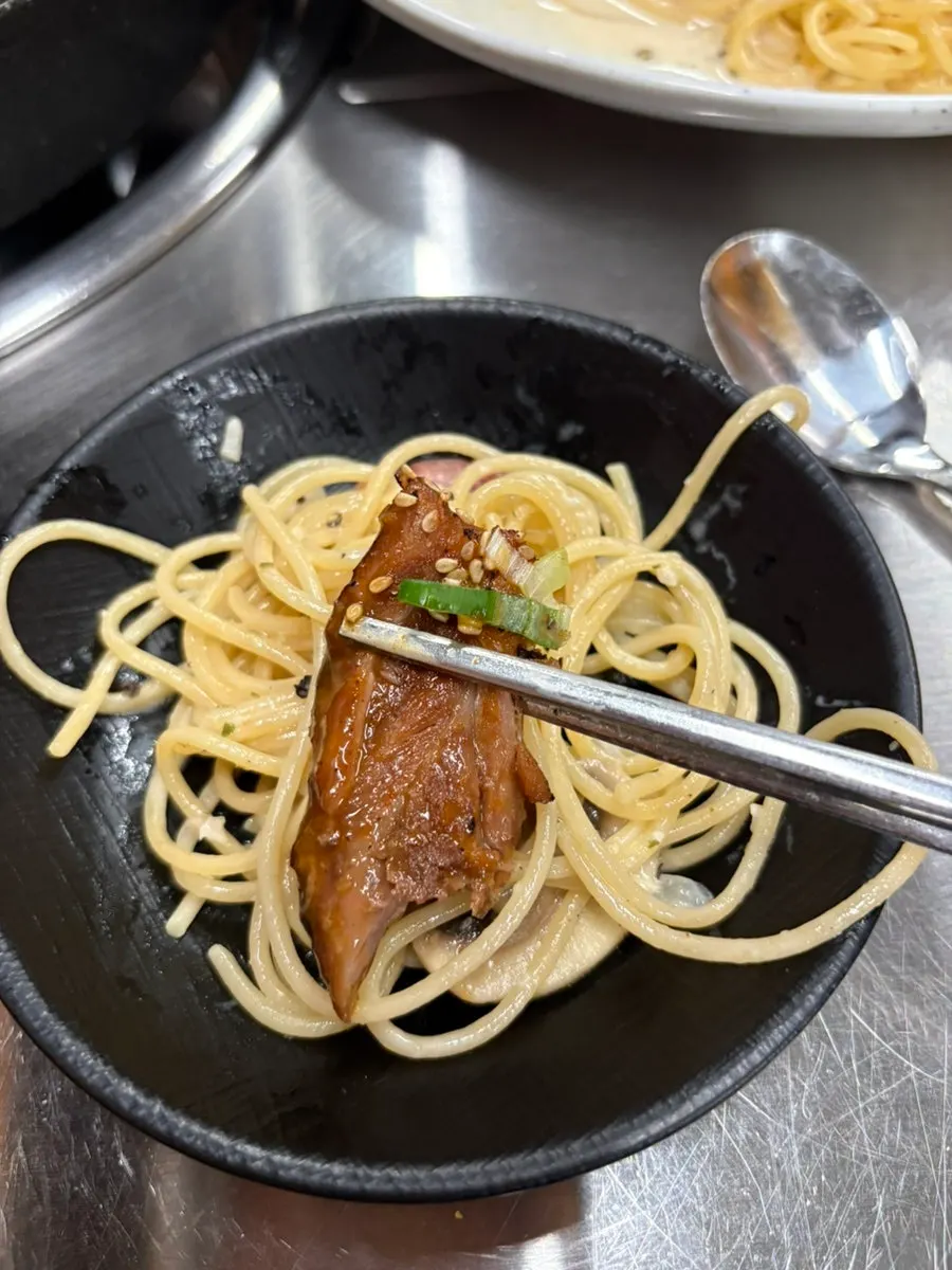 Bone grill meat piled on top of the pasta