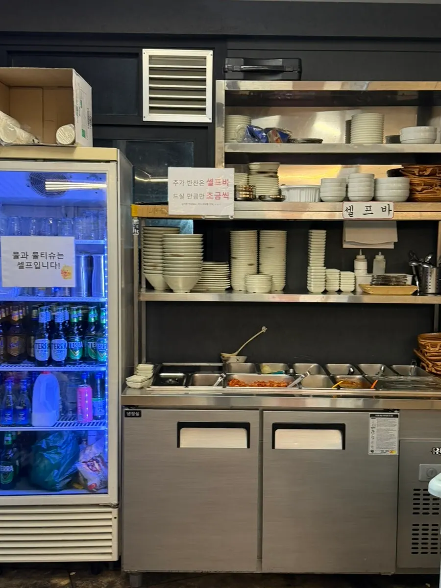 Self-bar with side dishes and vegetables at Suyeong Naengsam