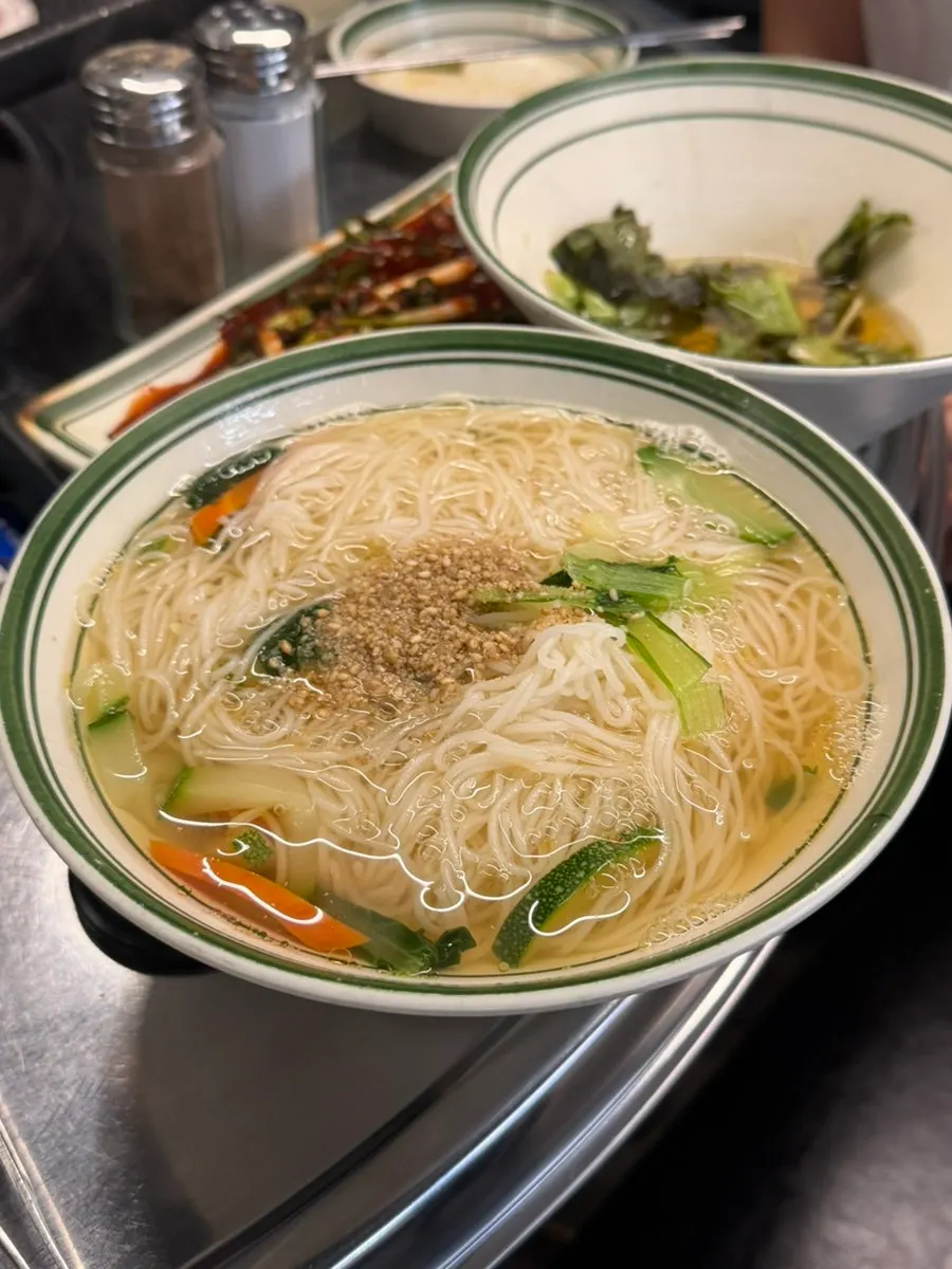 Naengsam topped with green onion kimchi