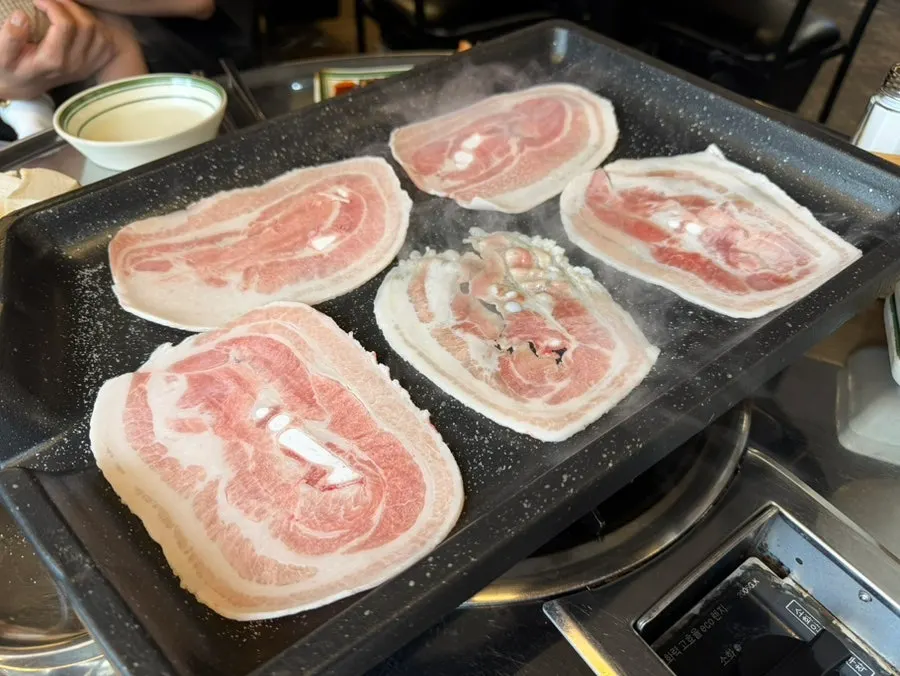 Staff grilling the naengsam pork belly