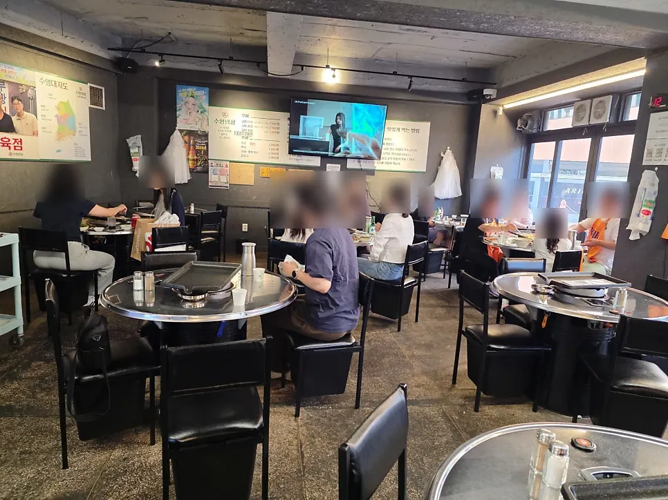 Table area on the right side of the restaurant with a TV