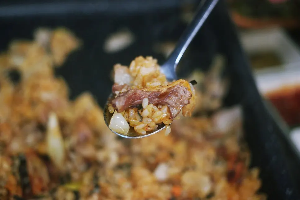 Fried rice cooked on the grill together with leftover meat