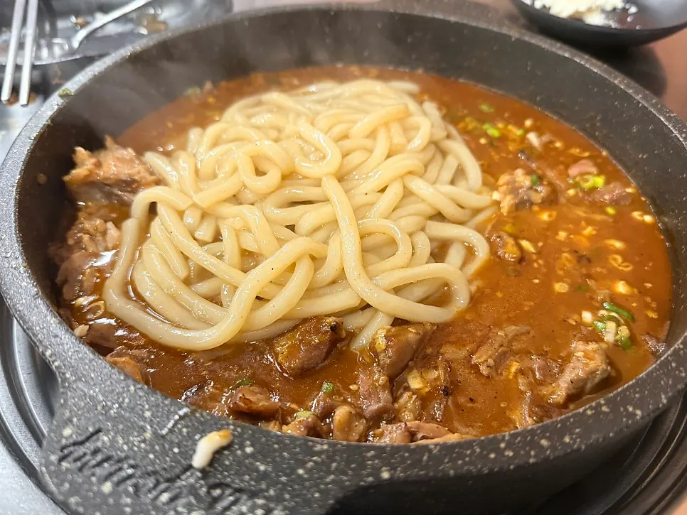 Stir-fried udon noodles mixed into the sauce