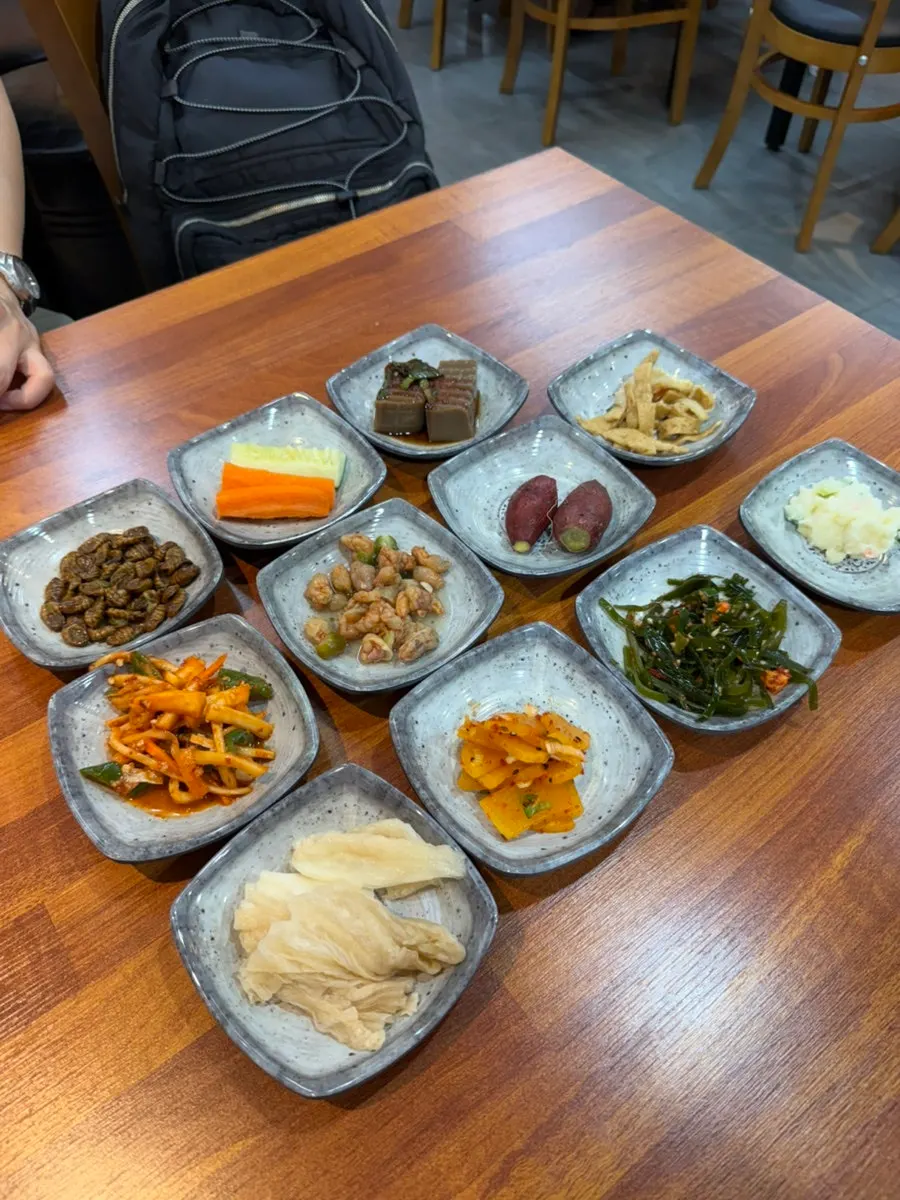 Table full of 11 side dishes