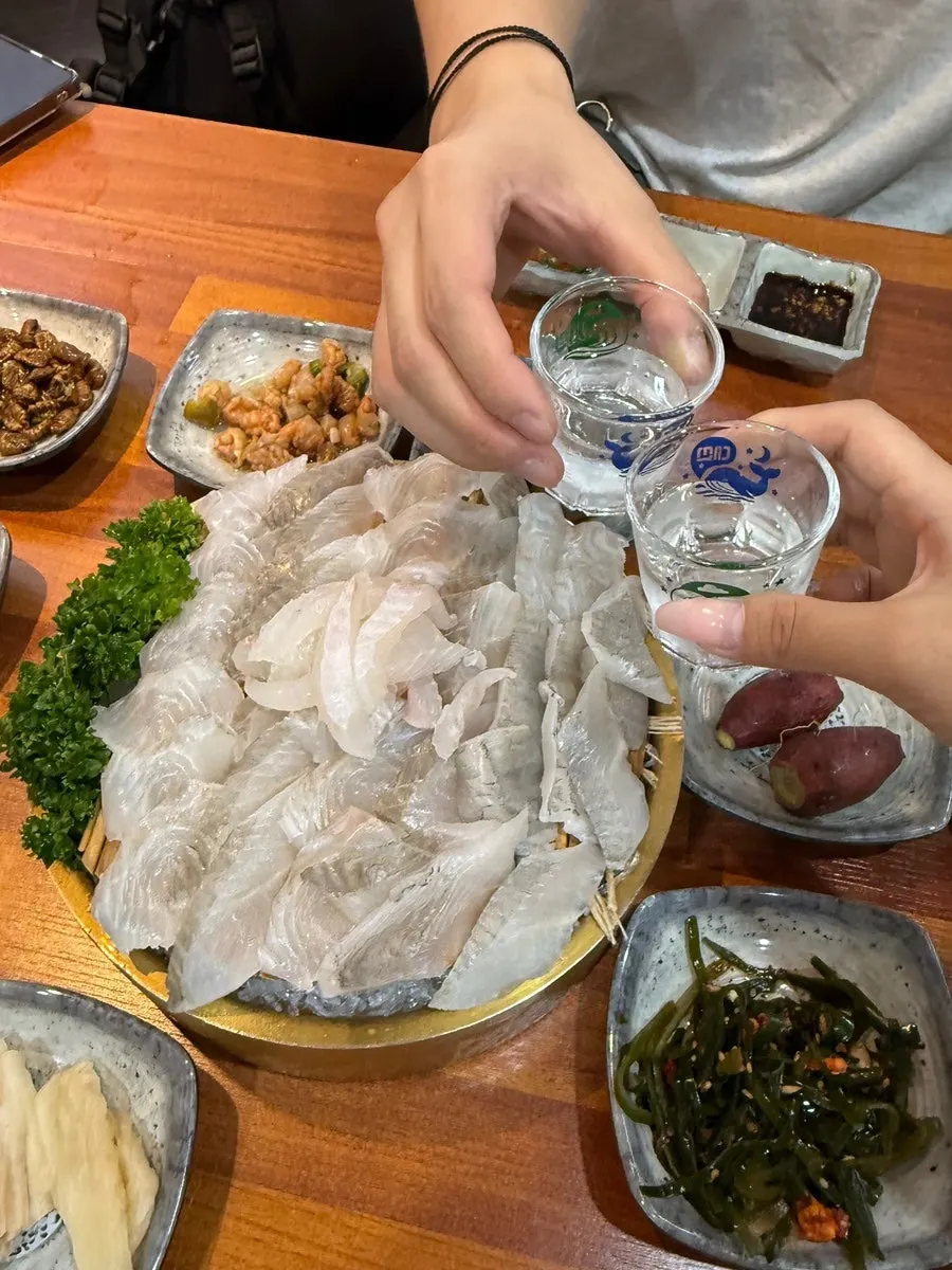 A glass of Cheongha next to the sashimi