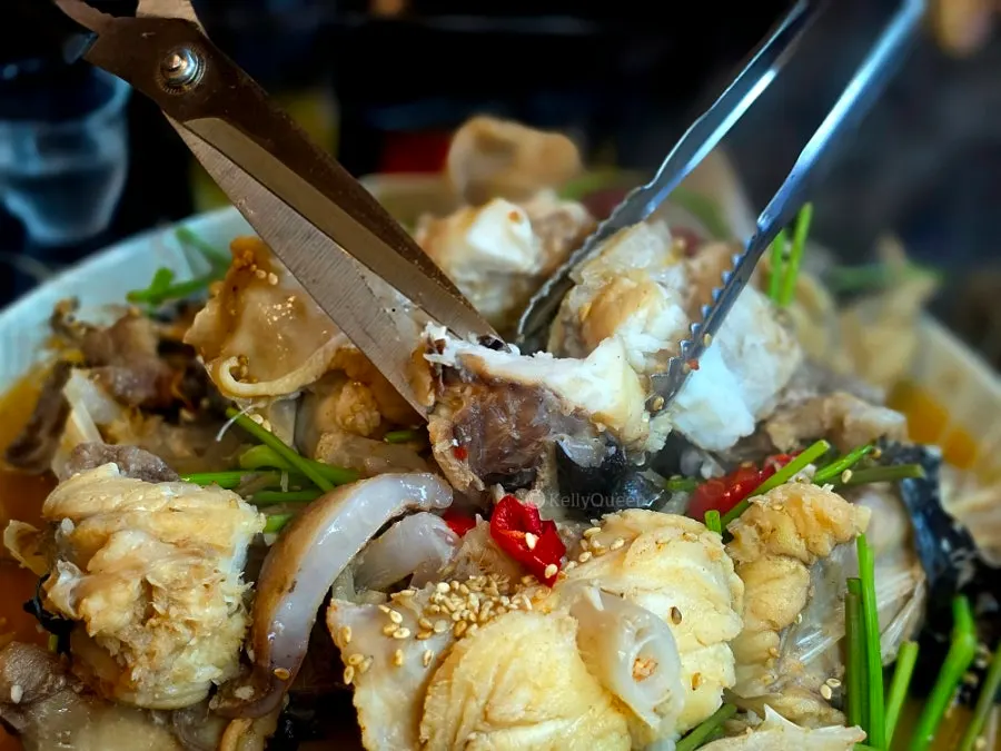 Cutting monkfish meat with scissors
