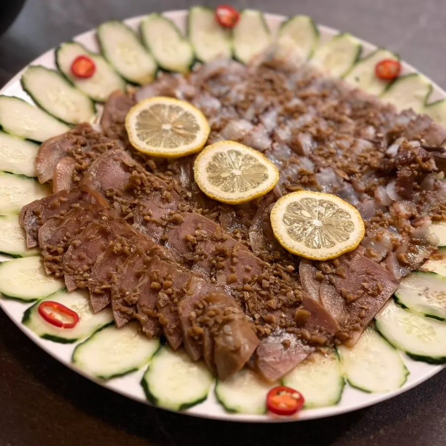 A bite combining octopus, meat, and cucumber