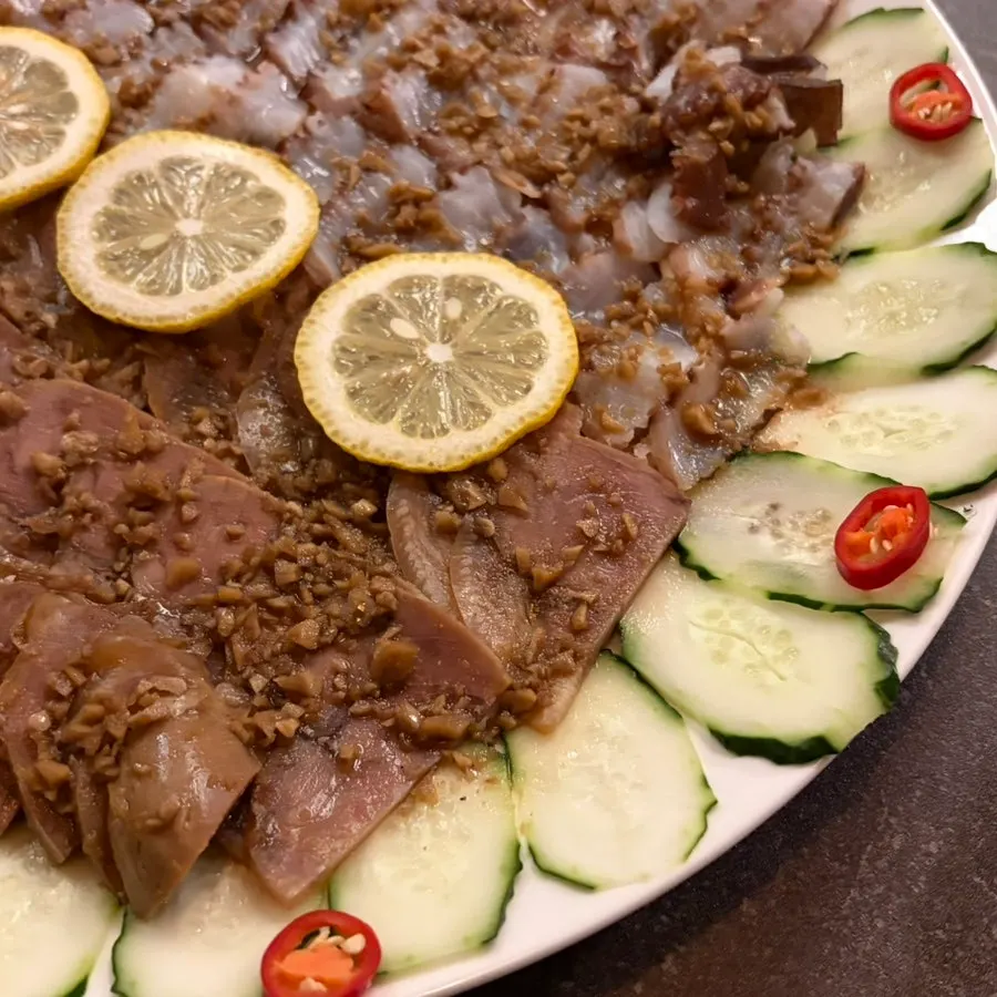 A piece of octopus and pork topped with seasoned onions
