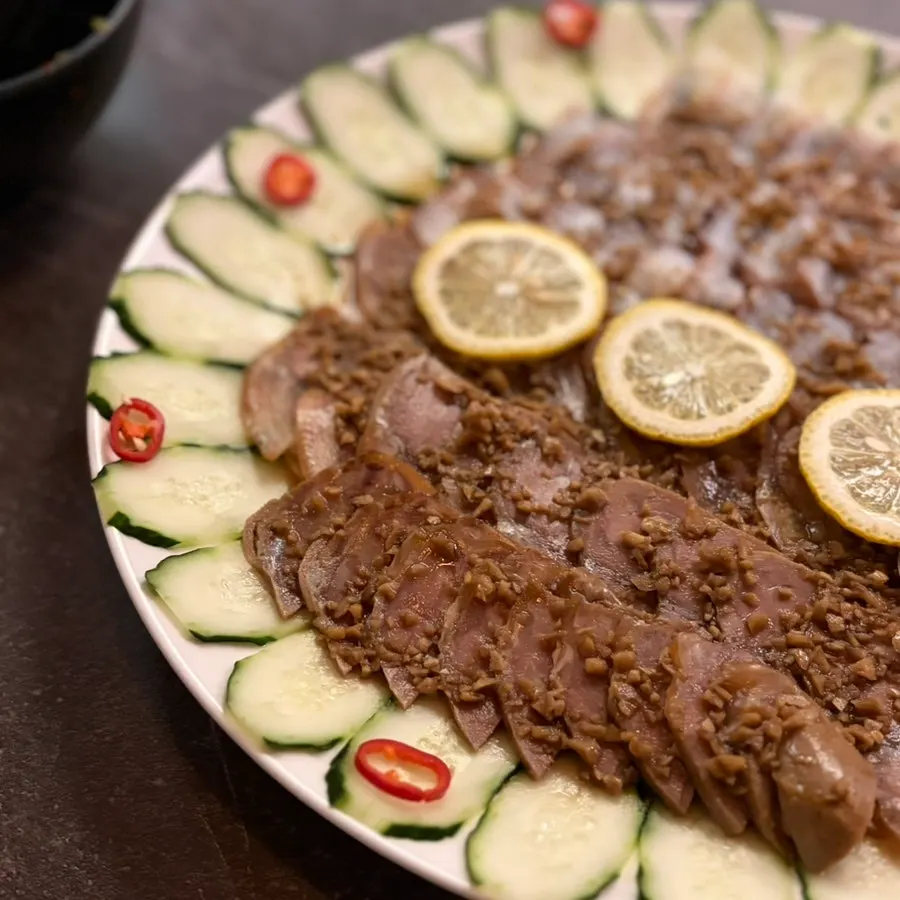 Close-up of octopus and pork dipped in sauce