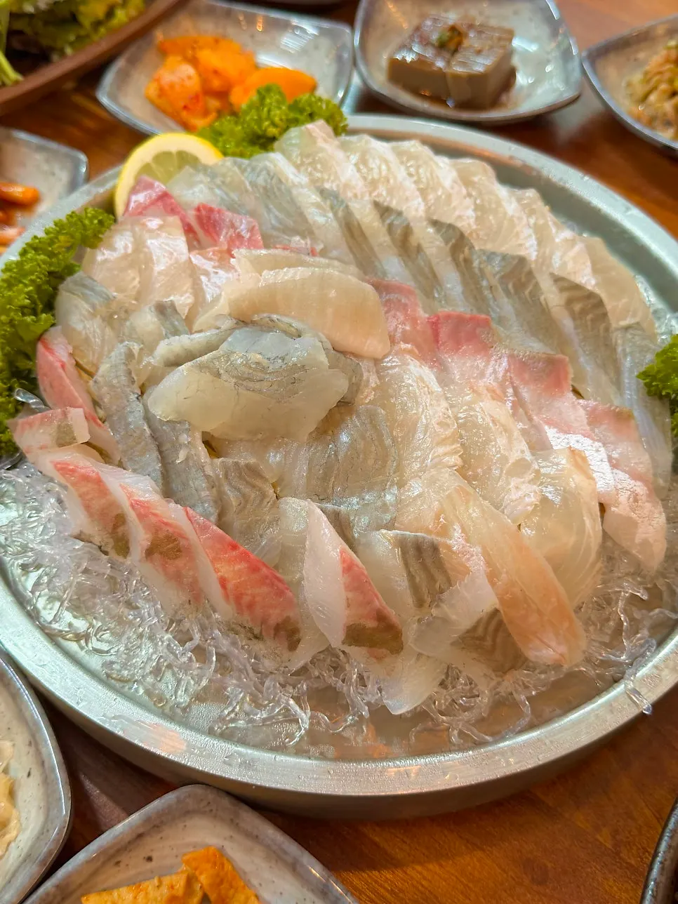A plate piled high with assorted sashimi