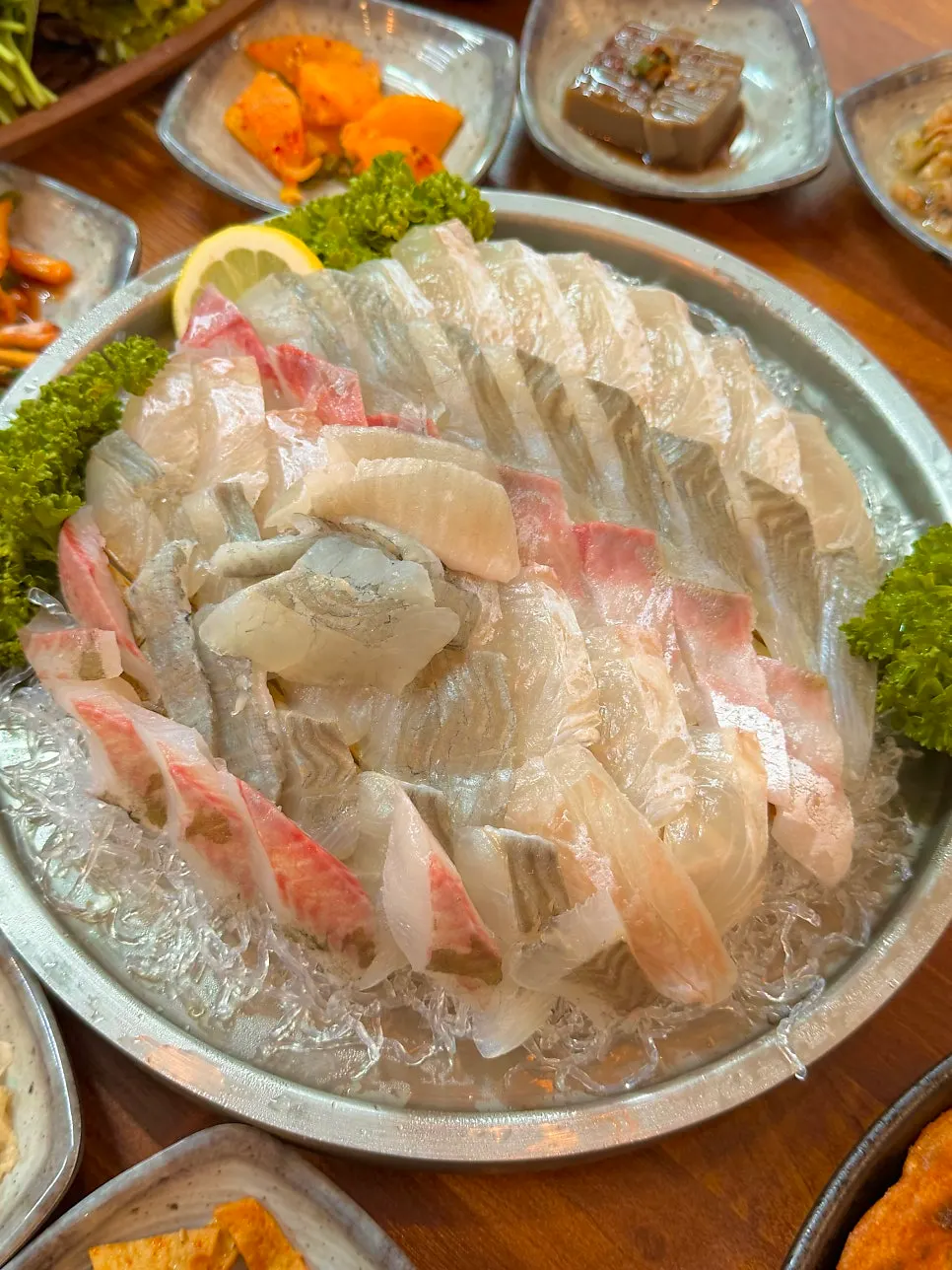A lettuce wrap of sashimi topped with makjang and chili