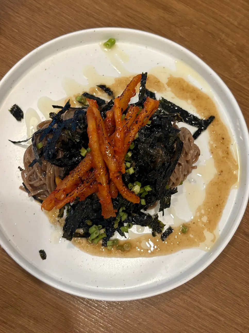 Seasoned grilled deodeok placed on top of the noodles