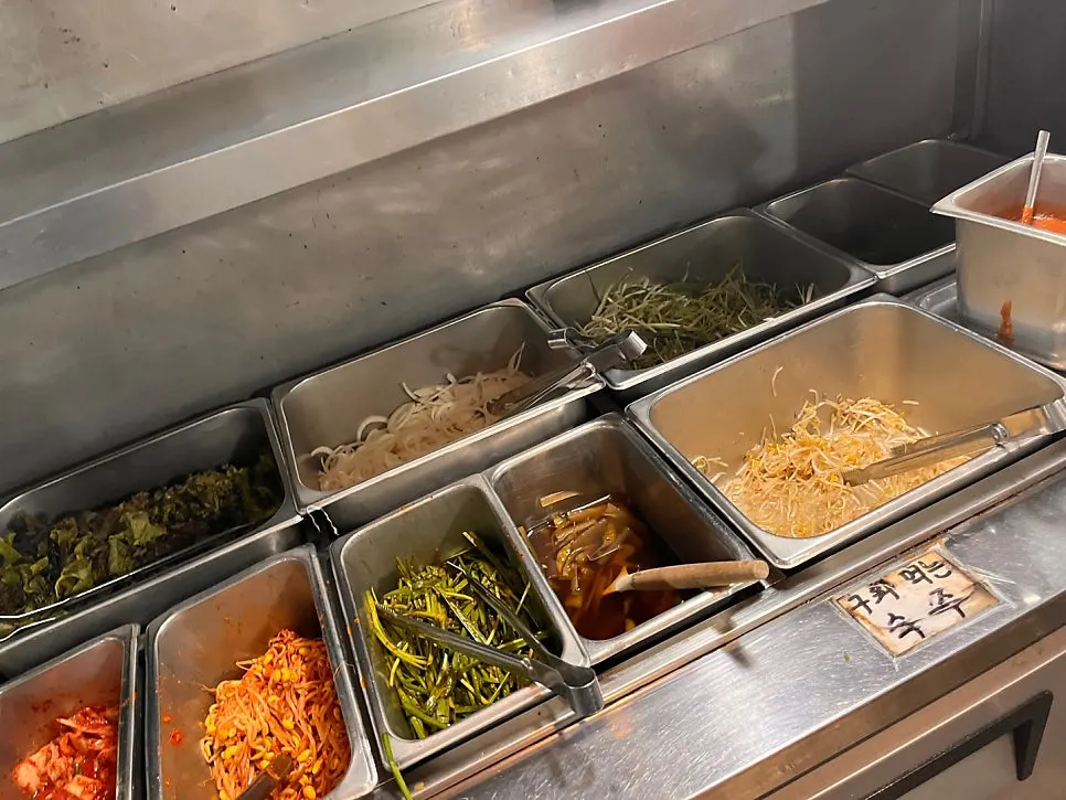 Self-serve side dish corner with kimchi and shredded scallions