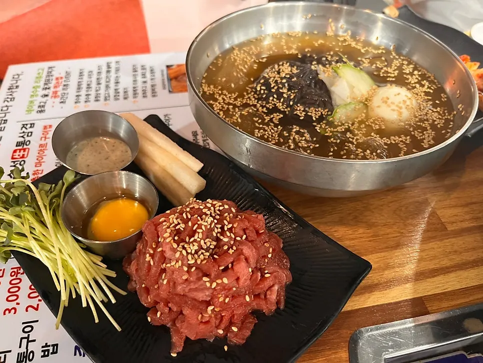Bright red beef tartare topped with an egg yolk