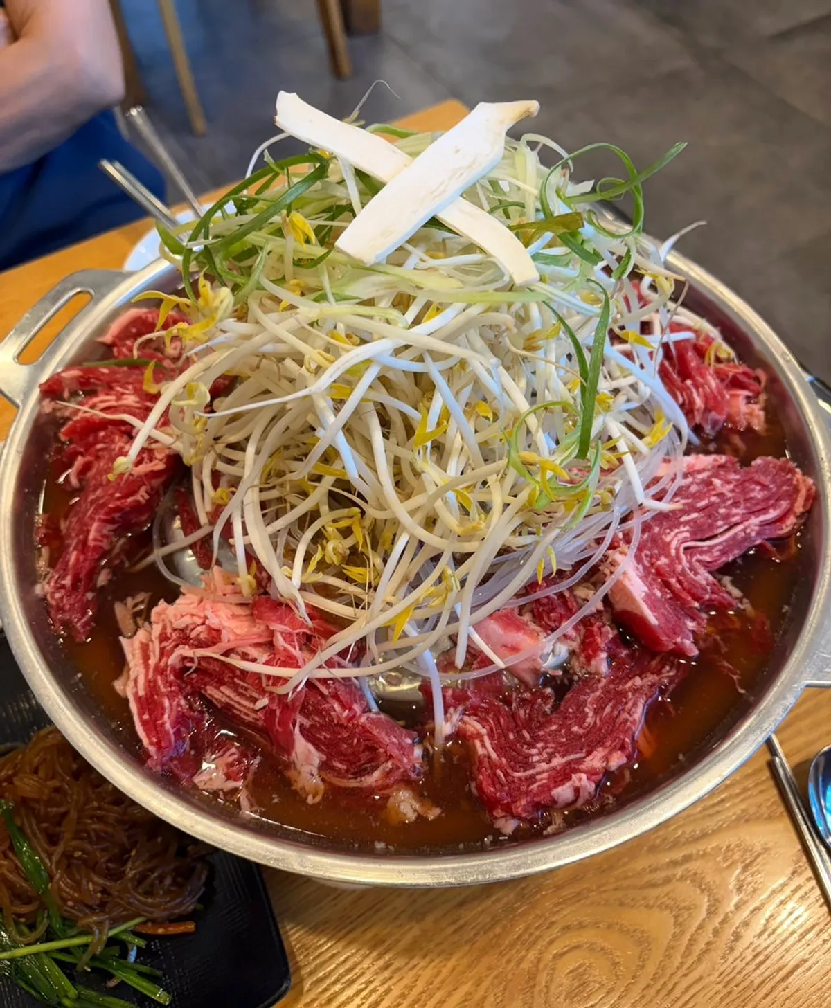 Seoul-style old bulgogi for two topped with green onion shreds