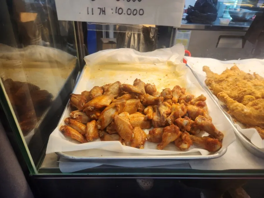 Sign showing dakgangjeong options: mild, medium-spicy, spicy