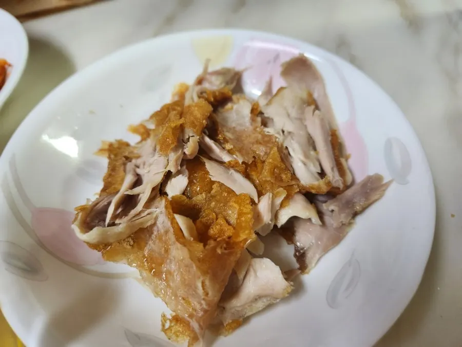 Old-style fried chicken drumstick eaten by hand