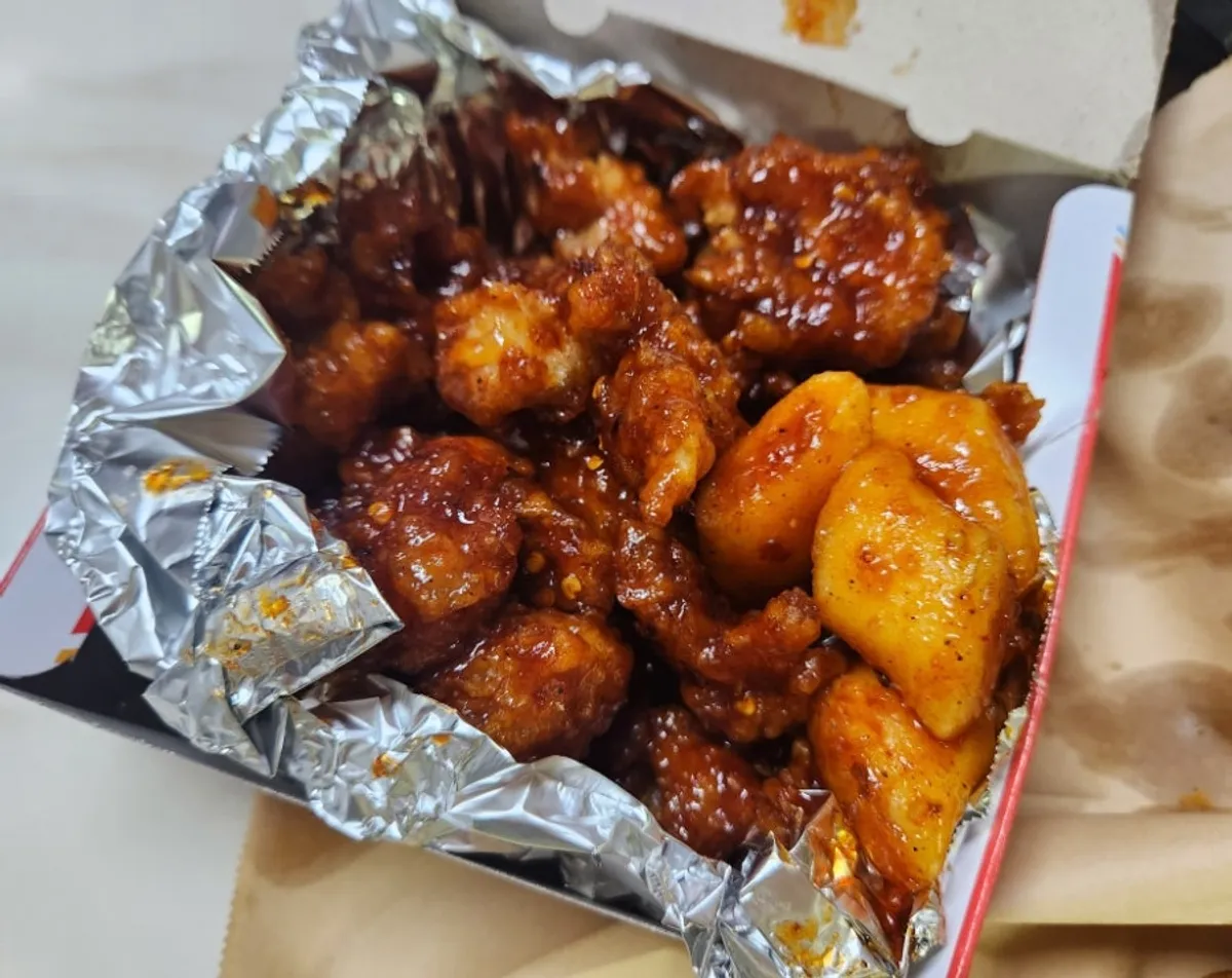 Close-up of medium-spicy dakgangjeong evenly coated in sauce