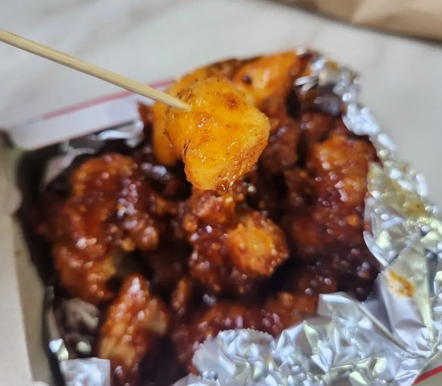 Cross-section of whole fried chicken showing moist meat