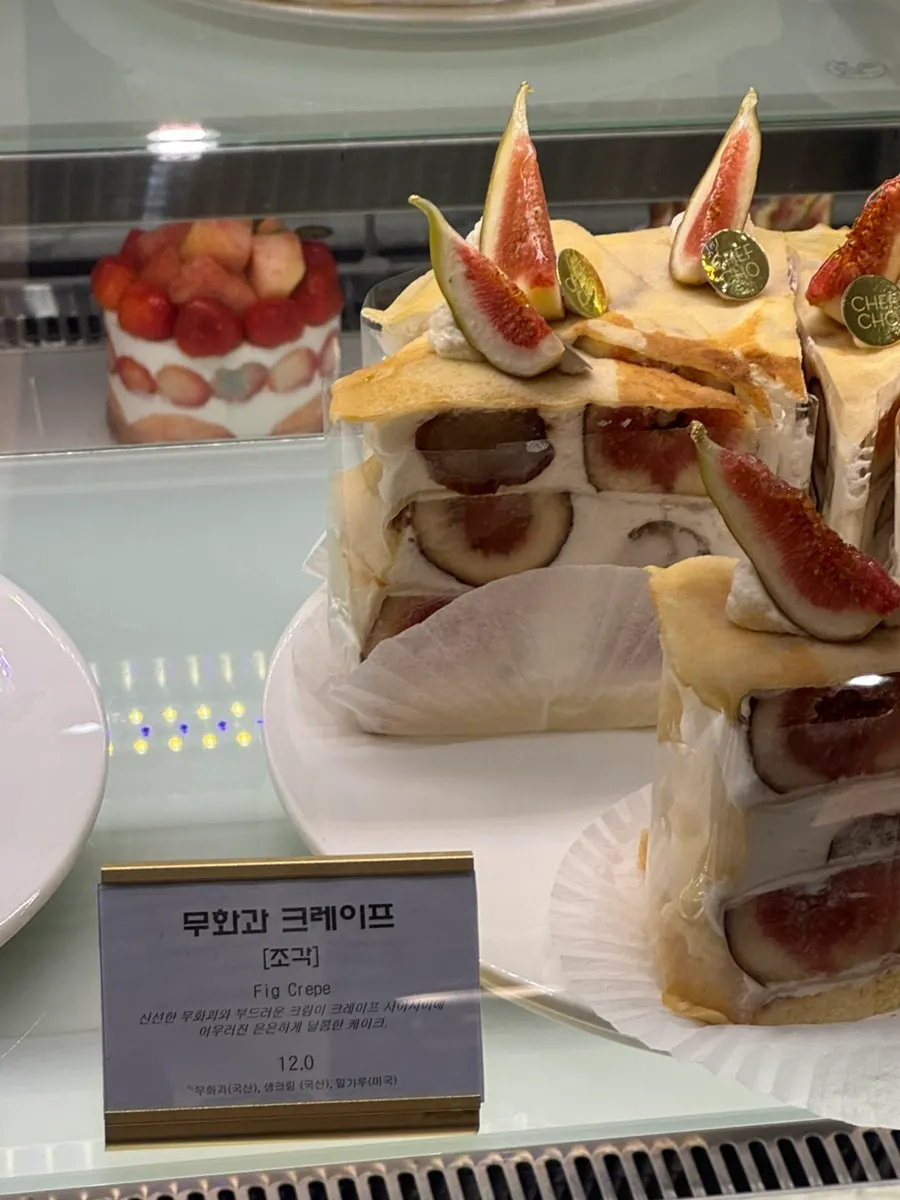 Display of cakes with chocolate cream and whole strawberries
