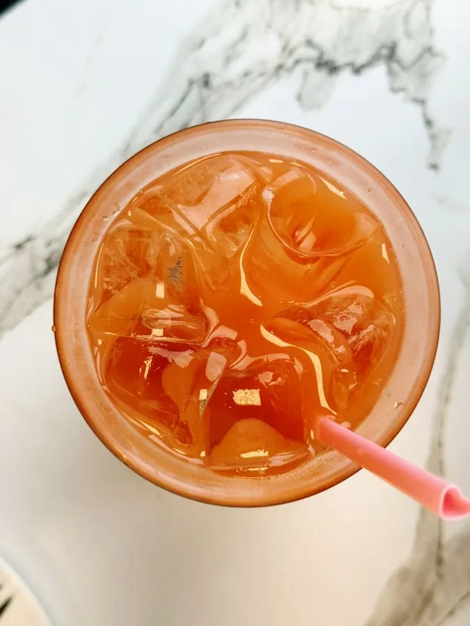 A glass of coral-colored grapefruit juice