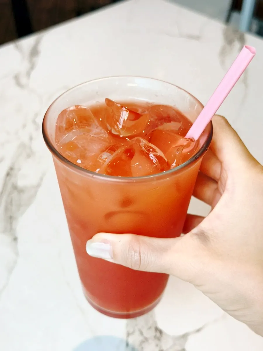 Close-up of grapefruit juice glowing through the ice