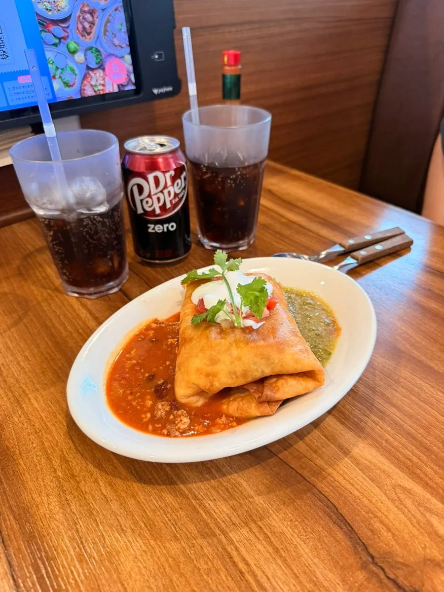 Plate of chimichanga served with sauce