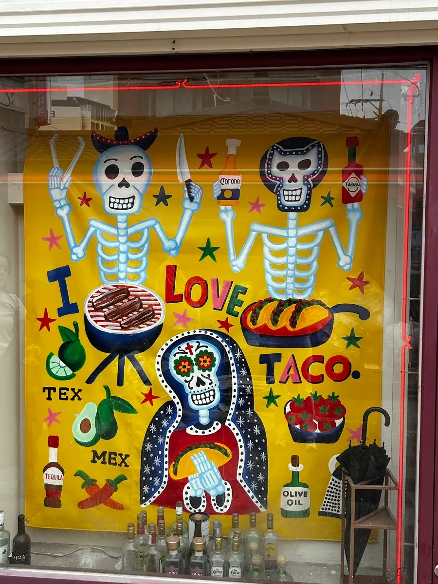 Taco Dot wall mural visible from the alley