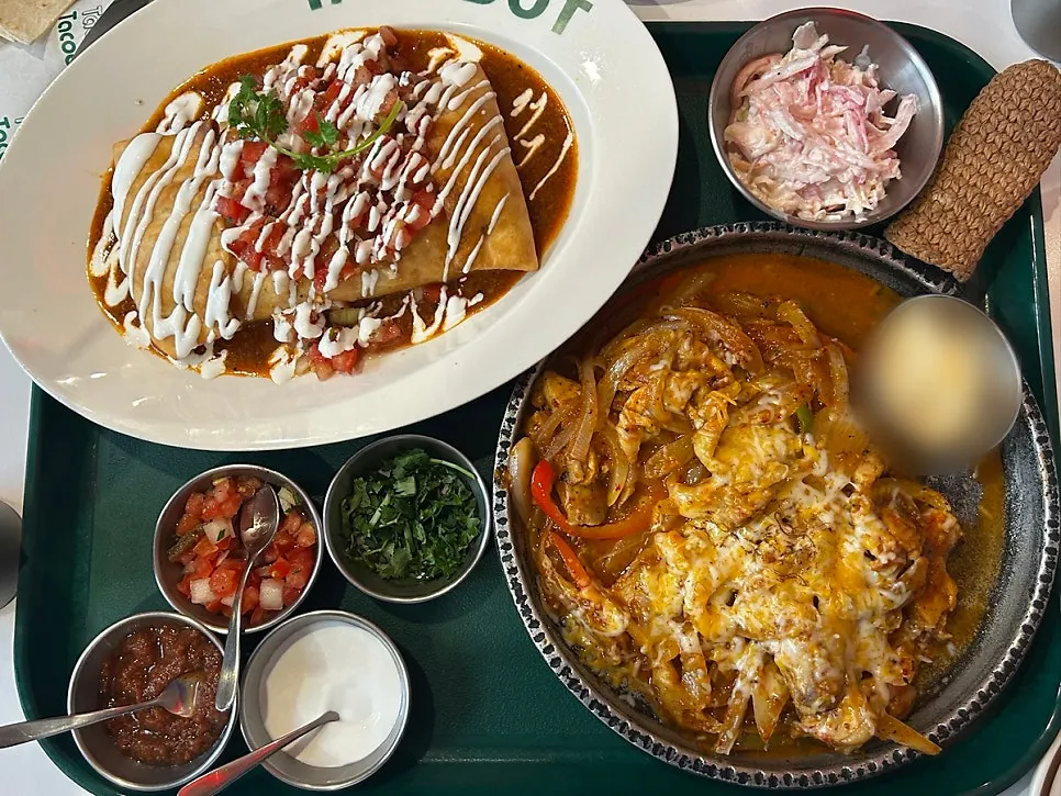 Chimichanga and fajita platter set on the table