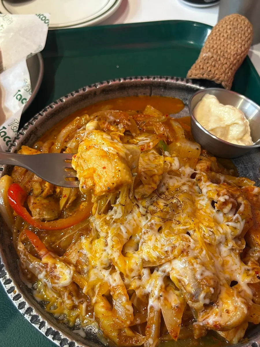 Fajita sides with cilantro, tomato, and sauces