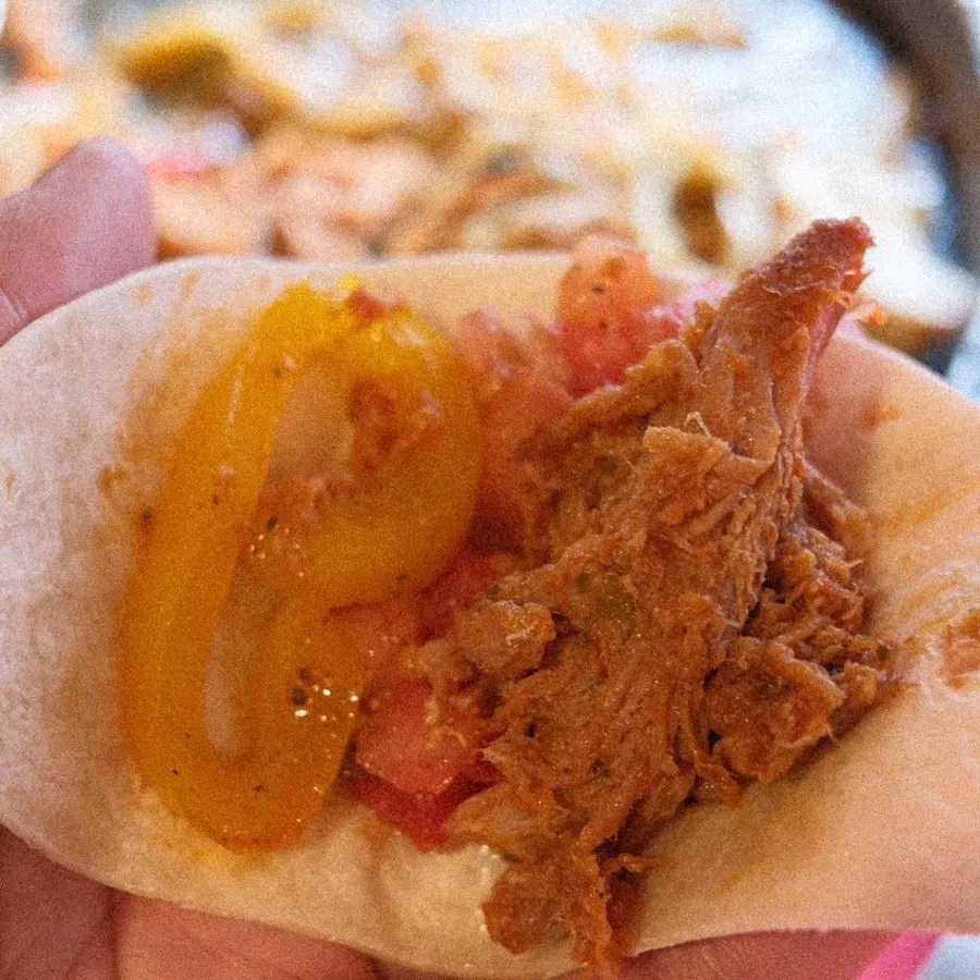 Taco with pulled pork, salsa and grilled onion