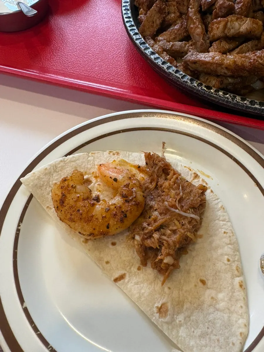 Tortilla topped with fajita fillings