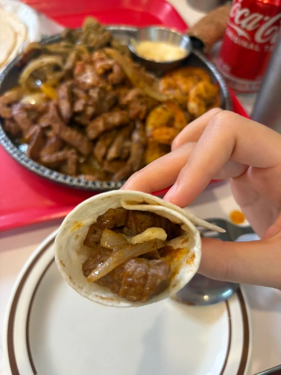 A generously wrapped bite of fajita