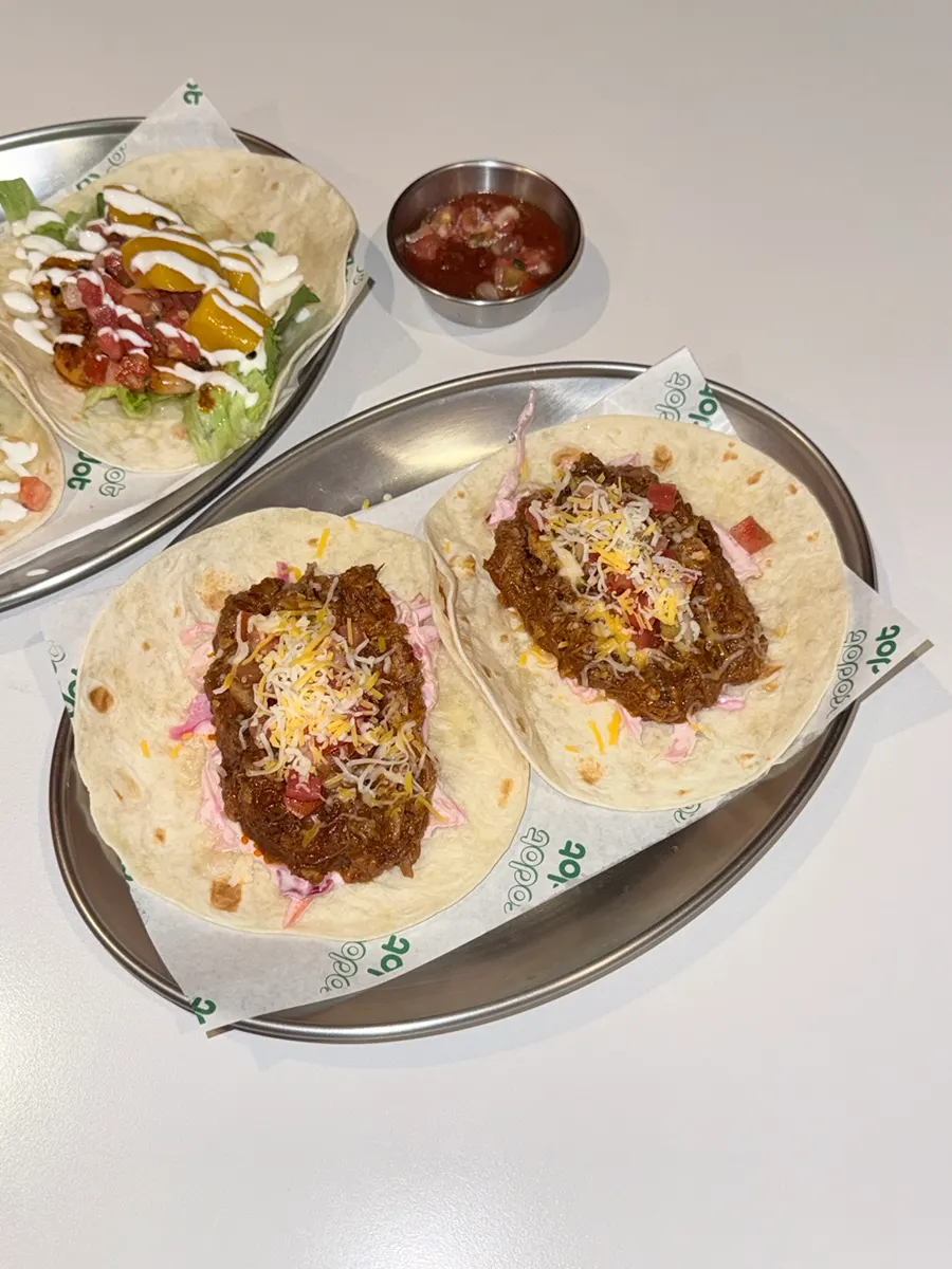 Cross-section of shrimp taco topped with mango salsa