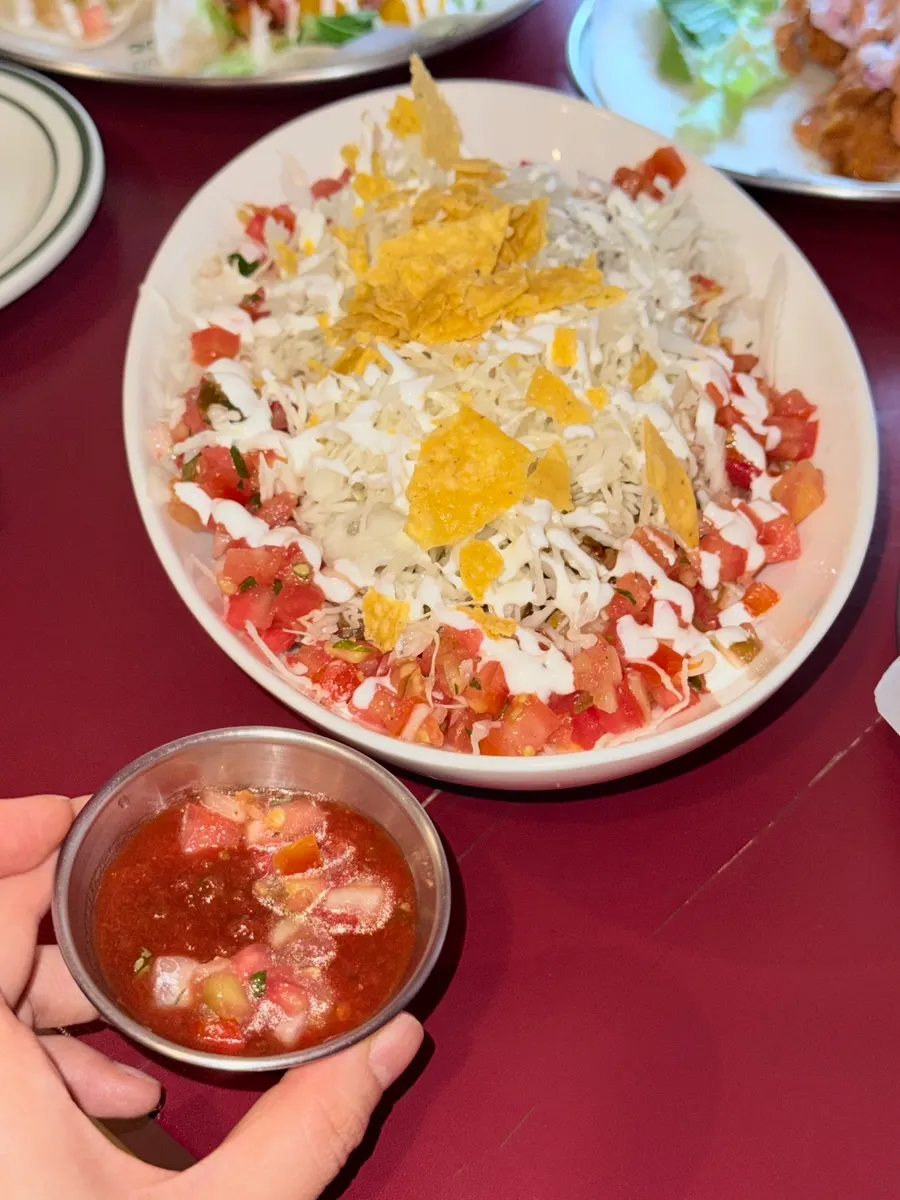 Tortilla bowl of Okinawan tacorice with jerk chicken