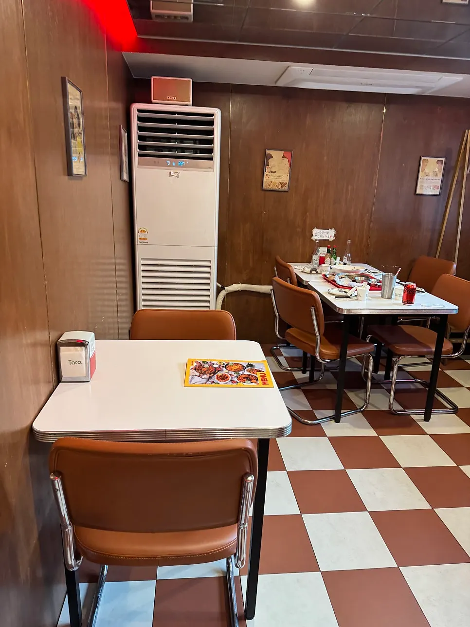 Retro interior with brown tables and checkered flooring
