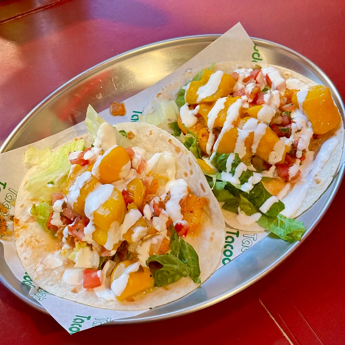 Mango shrimp taco topped with mango and shrimp