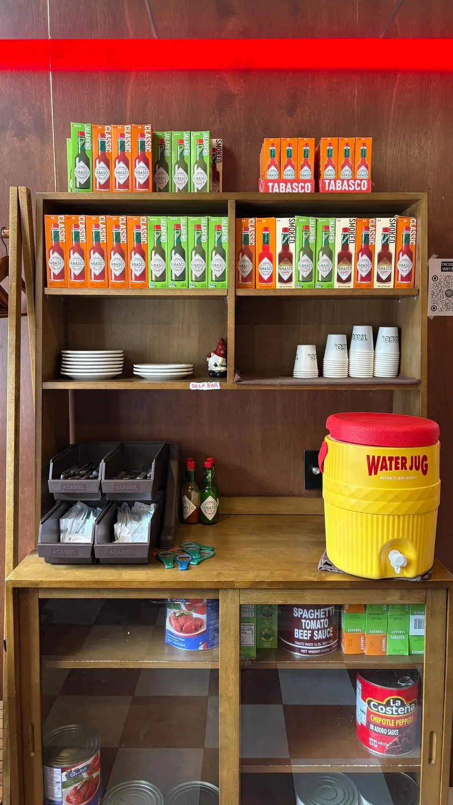 Interior space with coat hanger and self-service station at Taco Dot