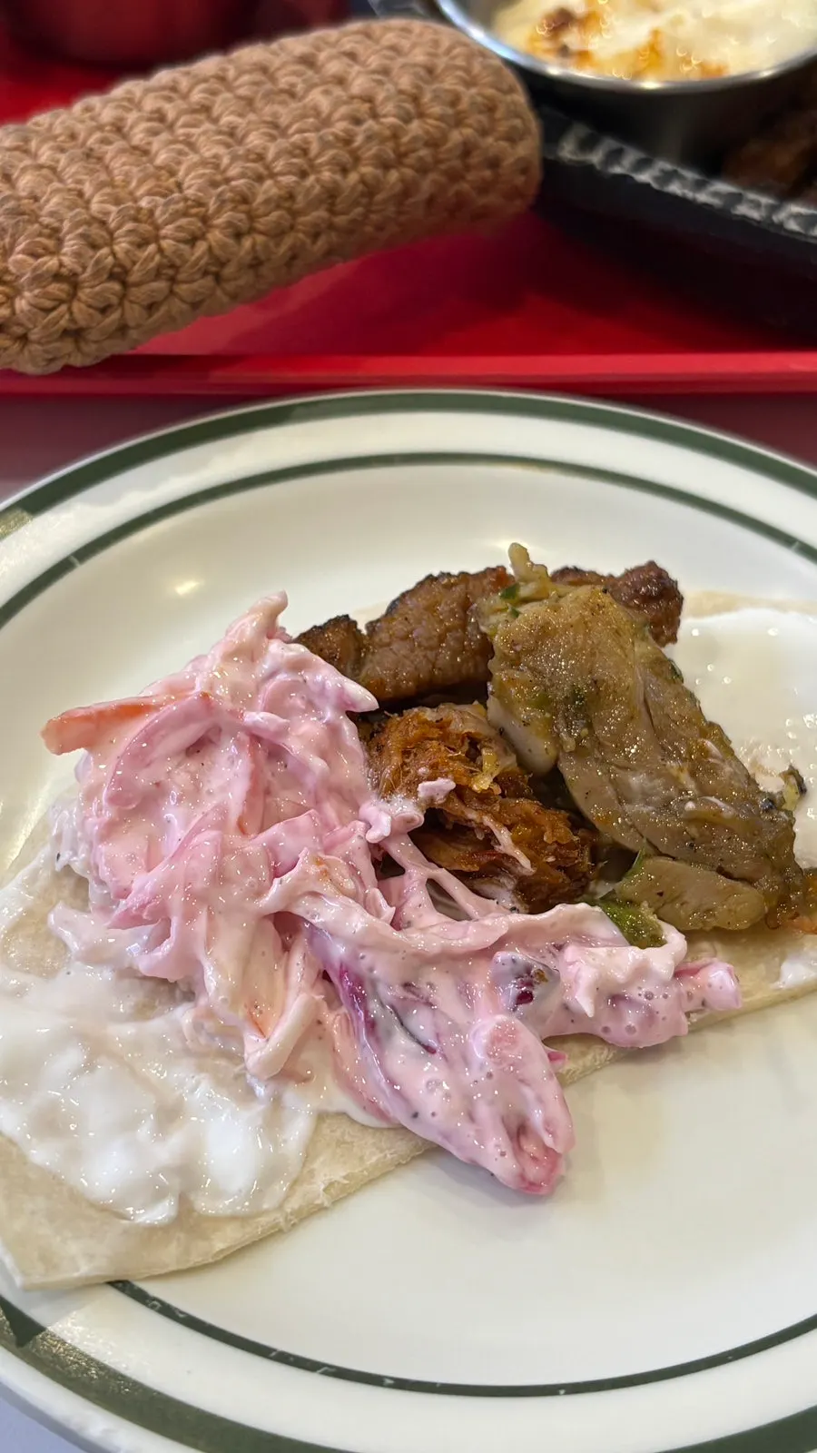 Wrapping meat and sauce in a tortilla